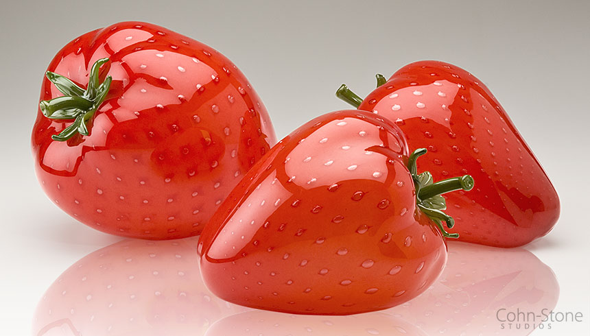 Larger-than-life hand blown glass strawberries by glass artists Michael Cohn and Molly Stone